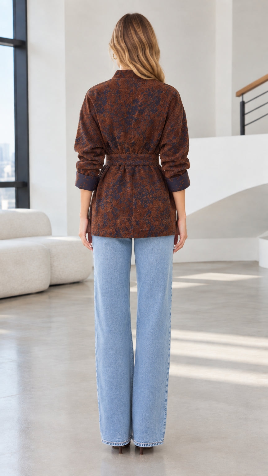 Back view of model wearing rust brown belted wrap jacket