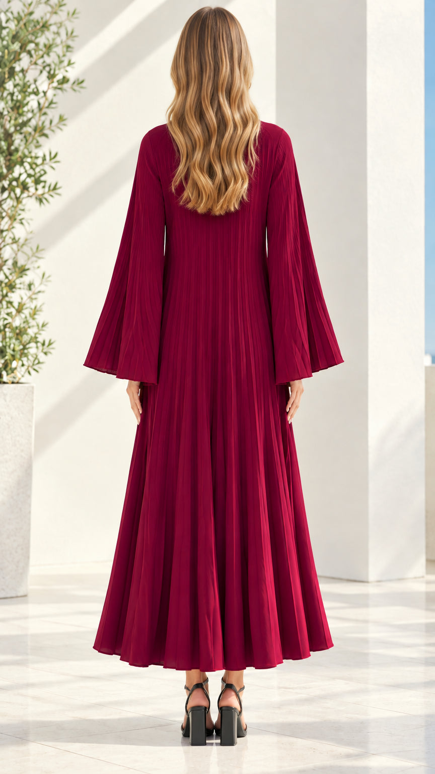 Back view of model wearing flowy burgundy pleated long sleeve maxi dress