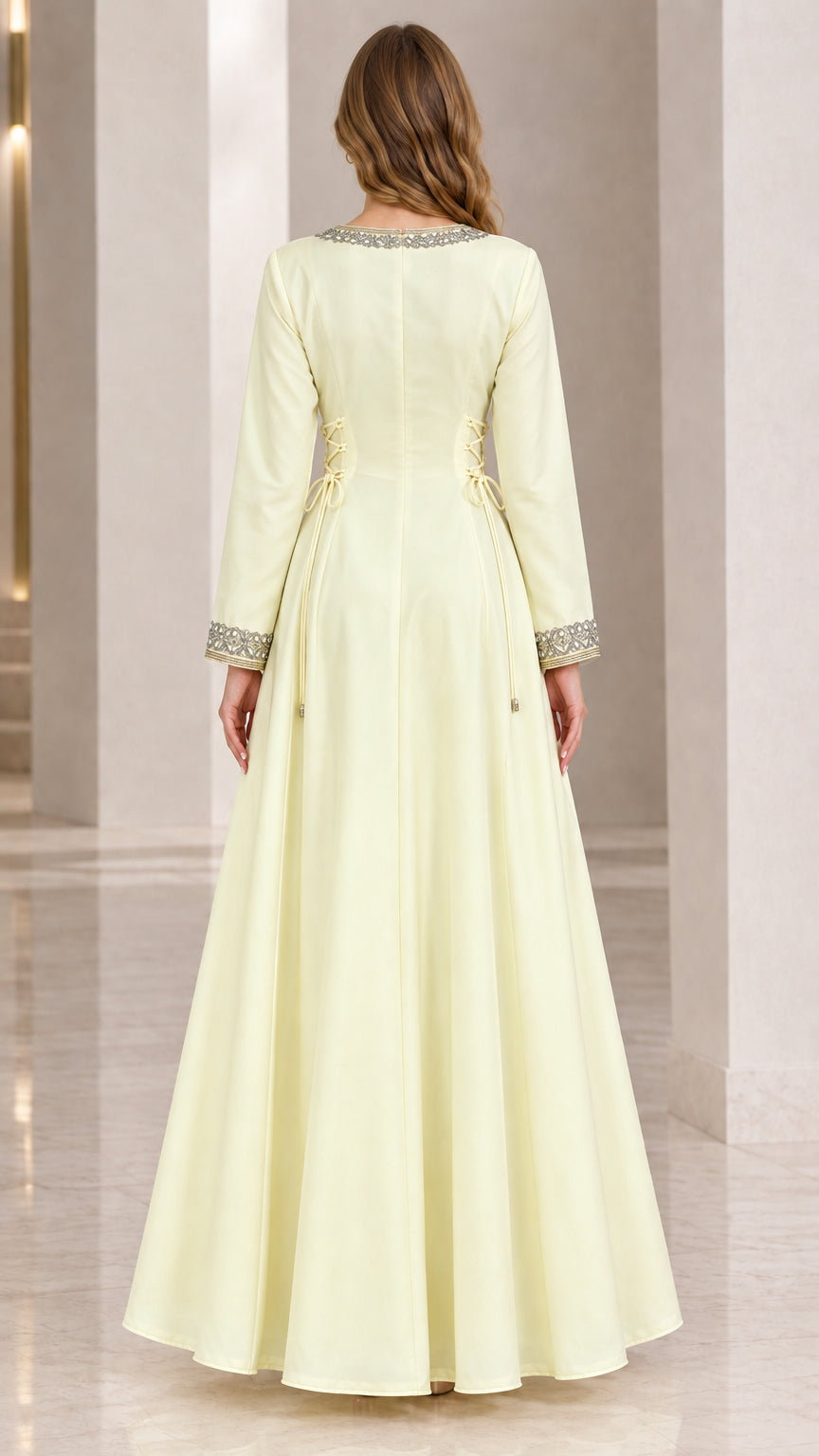 Back view of woman wearing pale yellow floor length kaftan dress