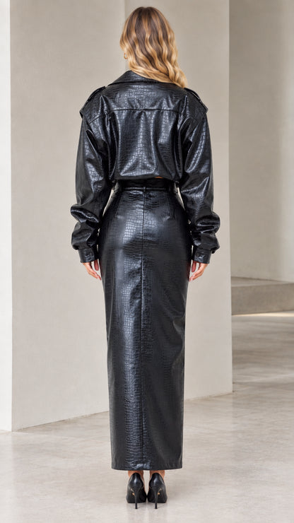Back view of model wearing black crocodile embossed faux leather cropped jacket and skirt