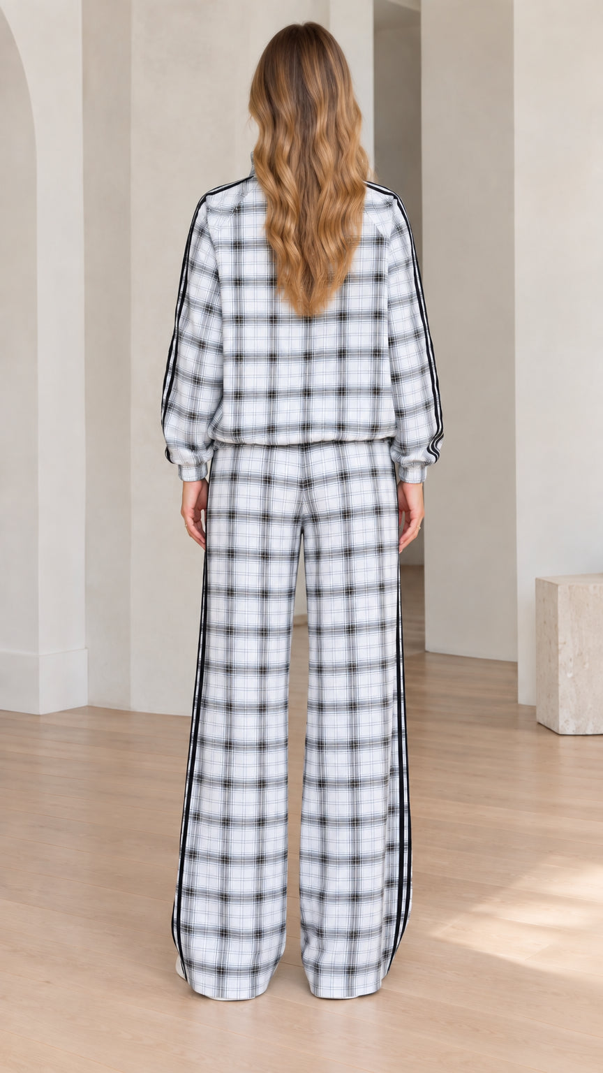 Back view of women's plaid tracksuit showing relaxed fit jacket and trousers
