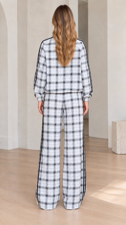 Back view of women's plaid tracksuit showing relaxed fit jacket and trousers