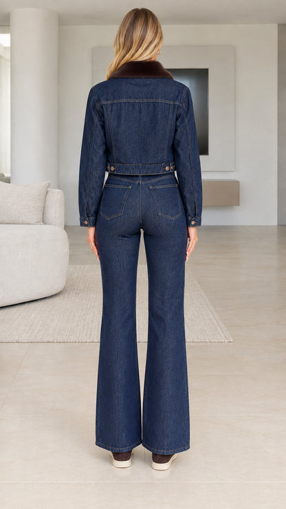 Back view of model wearing Indigo Blue denim jacket and flare jeans