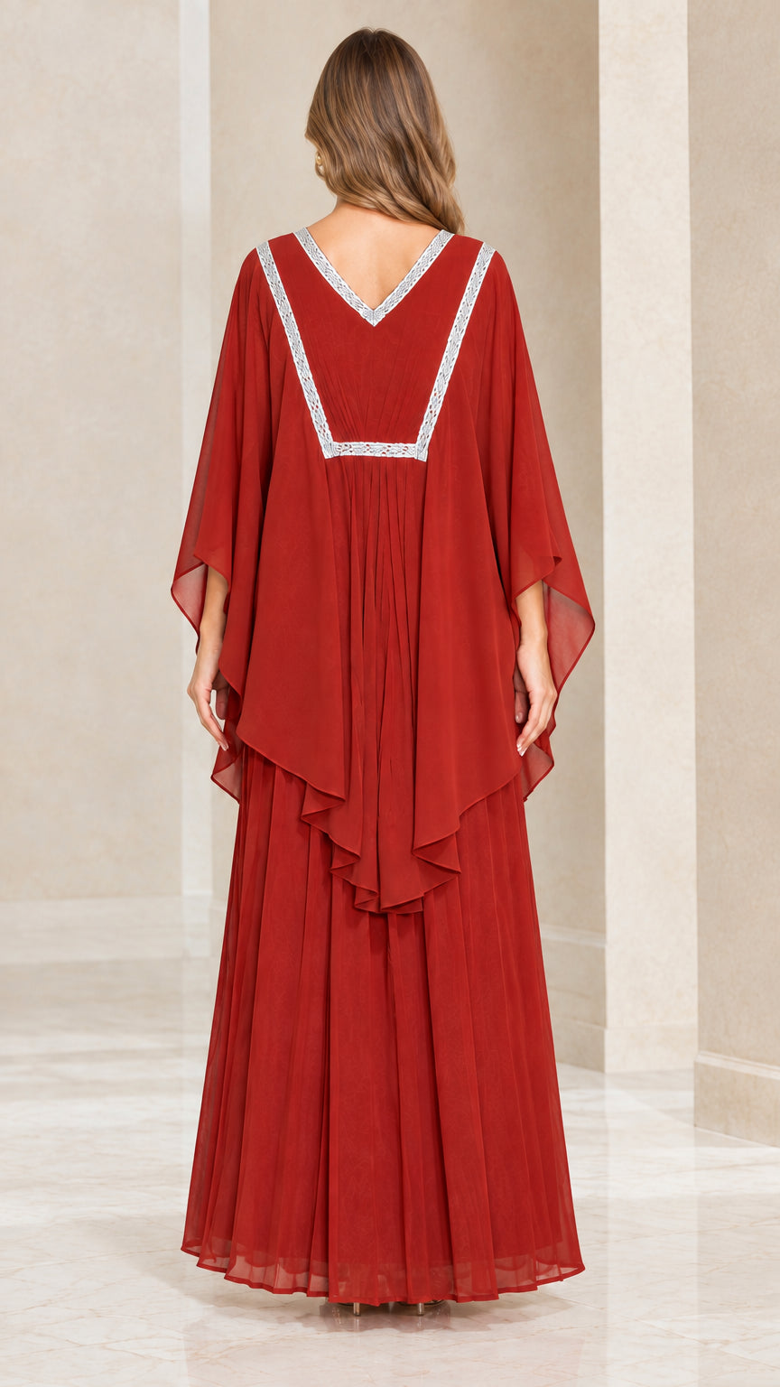 Back view of rust red maxi dress displaying embroidered V-back neckline and layered drape
