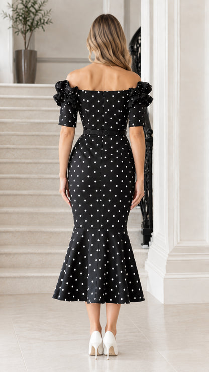 Back view of black polka dot midi dress with off-the-shoulder backline