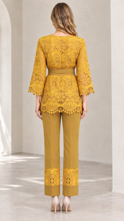 Back view of woman wearing mustard yellow belted lace top and straight-leg trousers
