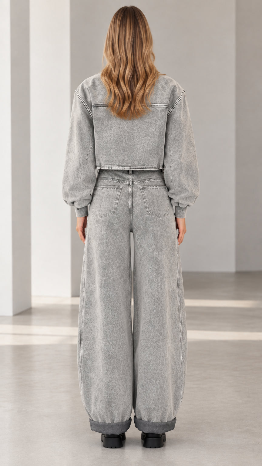 Back view of model wearing grey mineral wash cropped bomber and wide leg denim set
