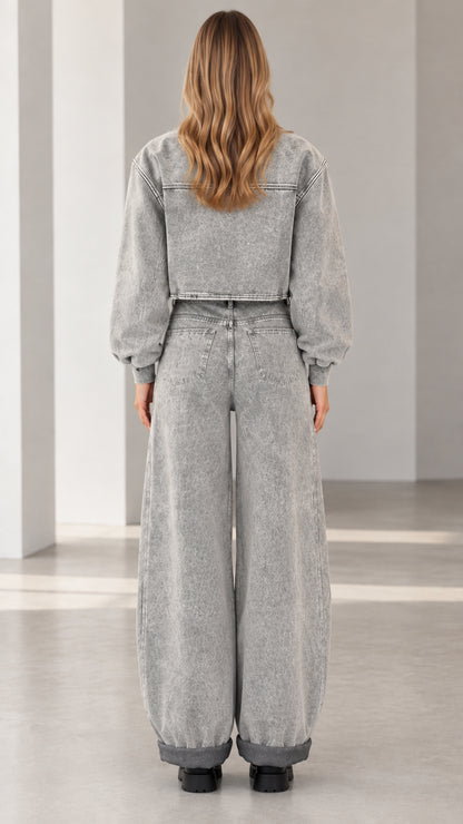 Back view of model wearing grey mineral wash cropped bomber and wide leg denim set