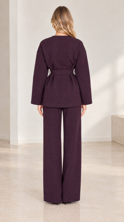 Back full-length view of deep plum long-sleeve belted tunic and wide trousers