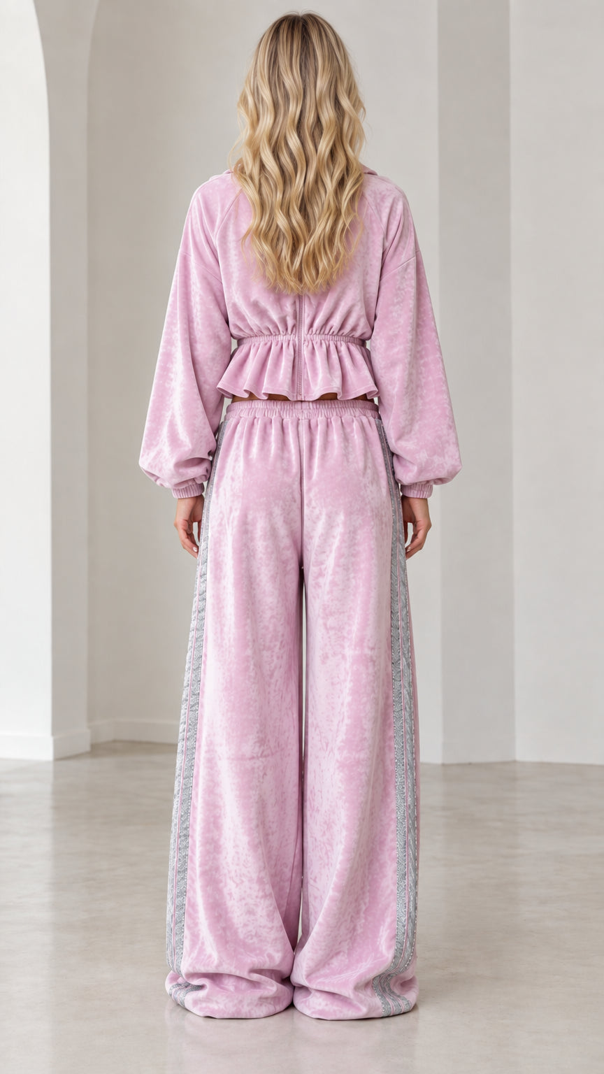 Back view of model wearing lilac pink velour cropped zip jacket and wide leg sweatpants