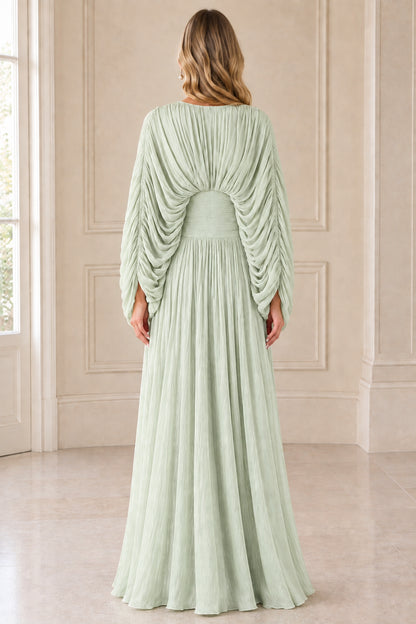 Back view of model in Sage Green pleated cape sleeve gown showing back waist detail