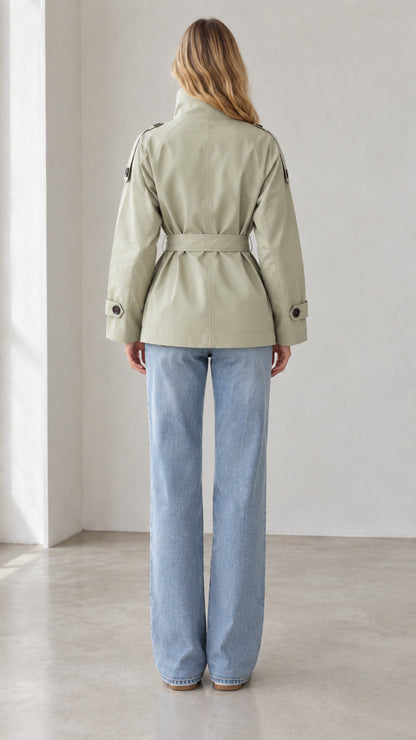 Back view of women's sage green short trench coat showing defined belted waist