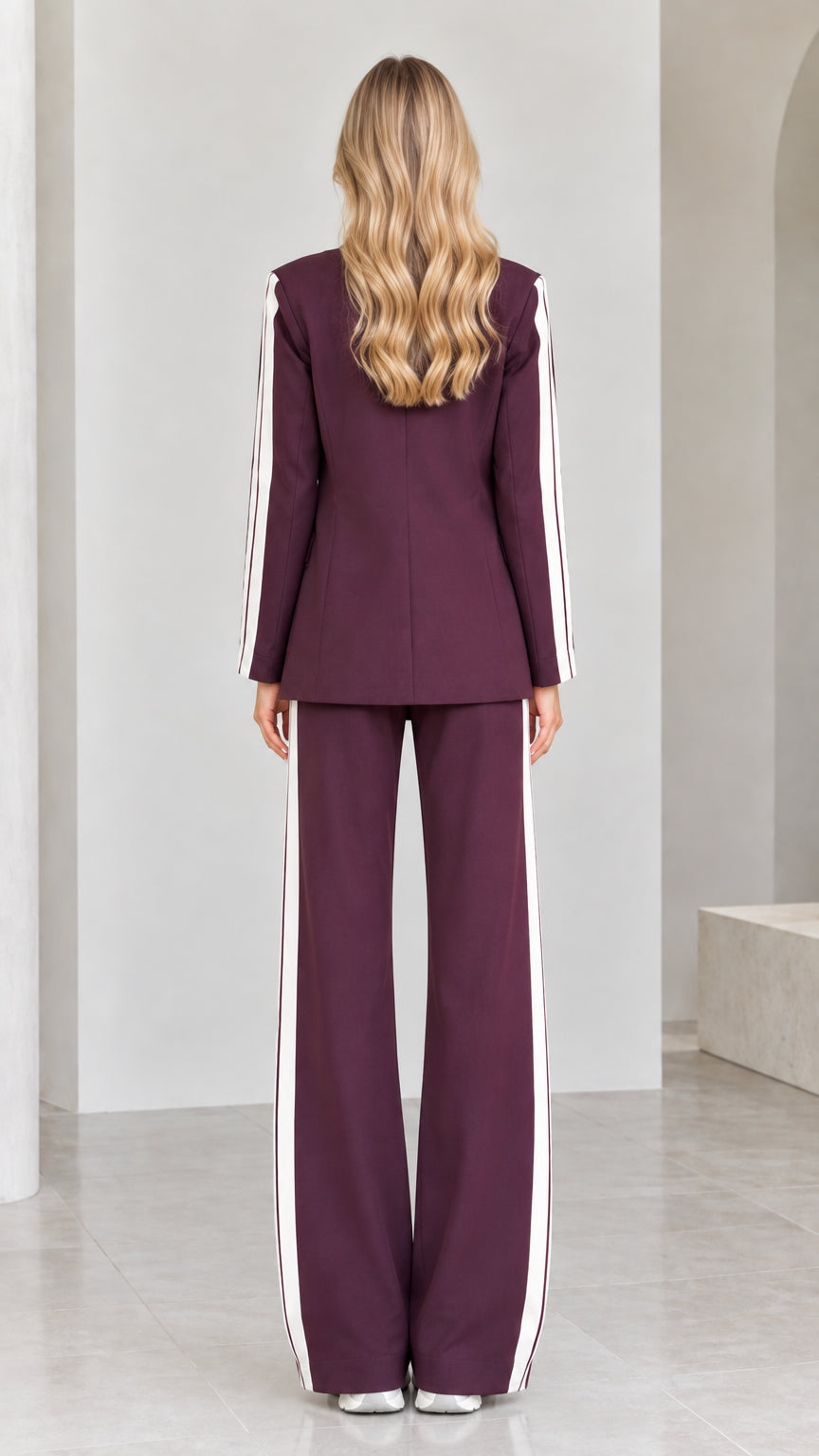 Back view of model in tailored burgundy blazer and wide-leg trousers