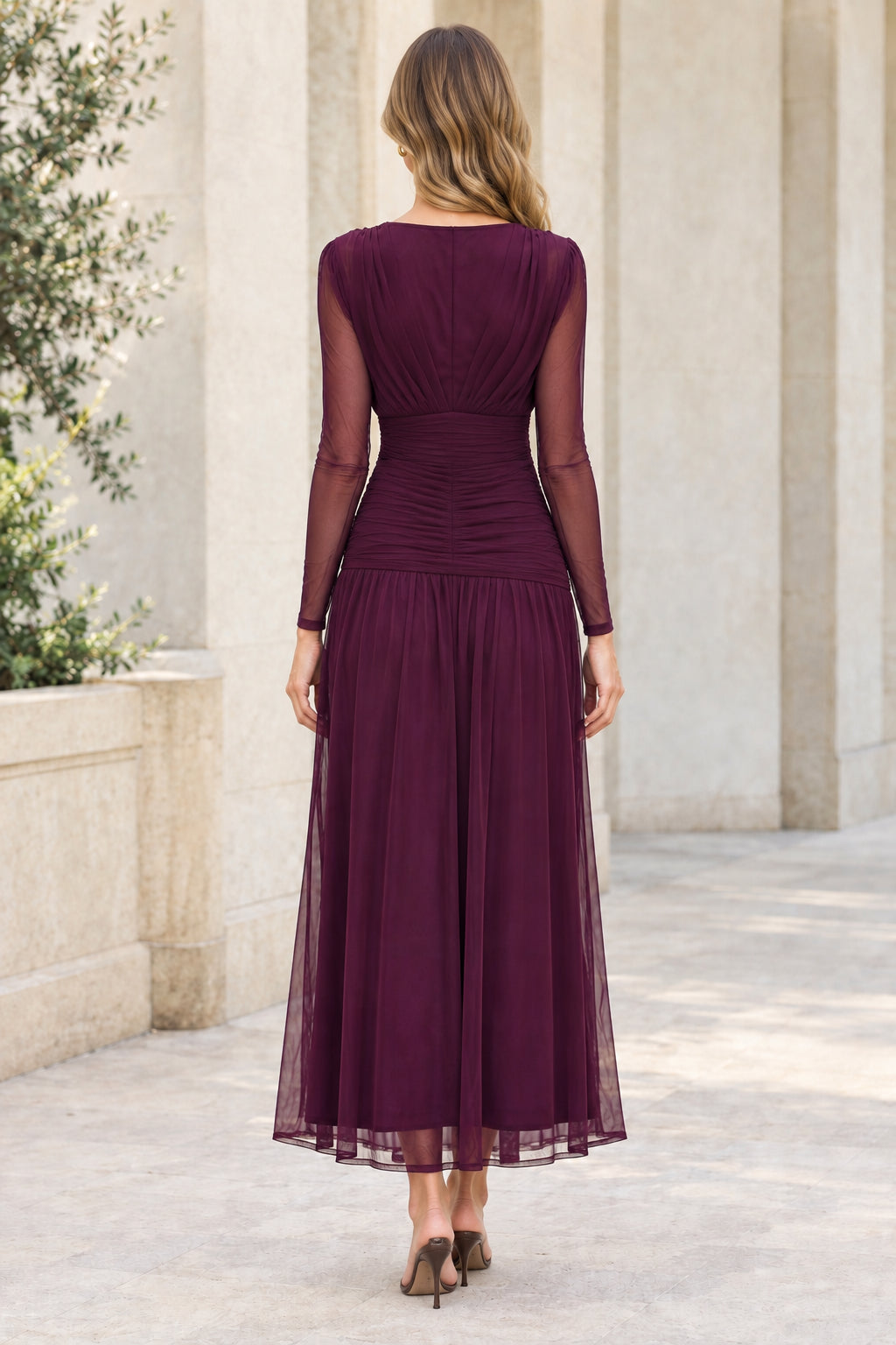 Back view of plum ruched mesh midi dress showing high back and flowing skirt