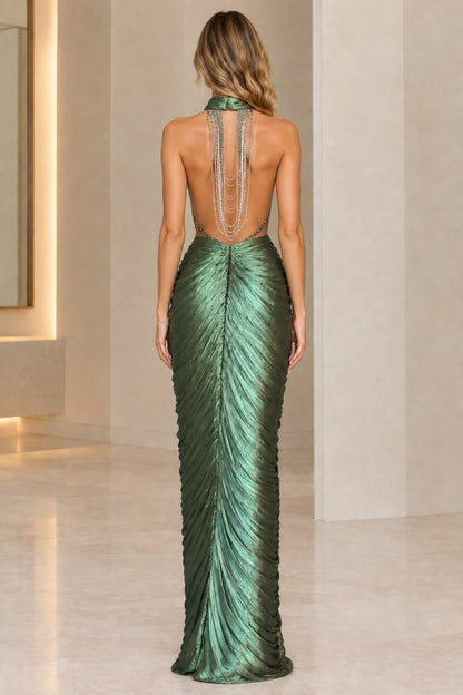 Back view of emerald green gown featuring dramatic open back with cascading silver chain details
