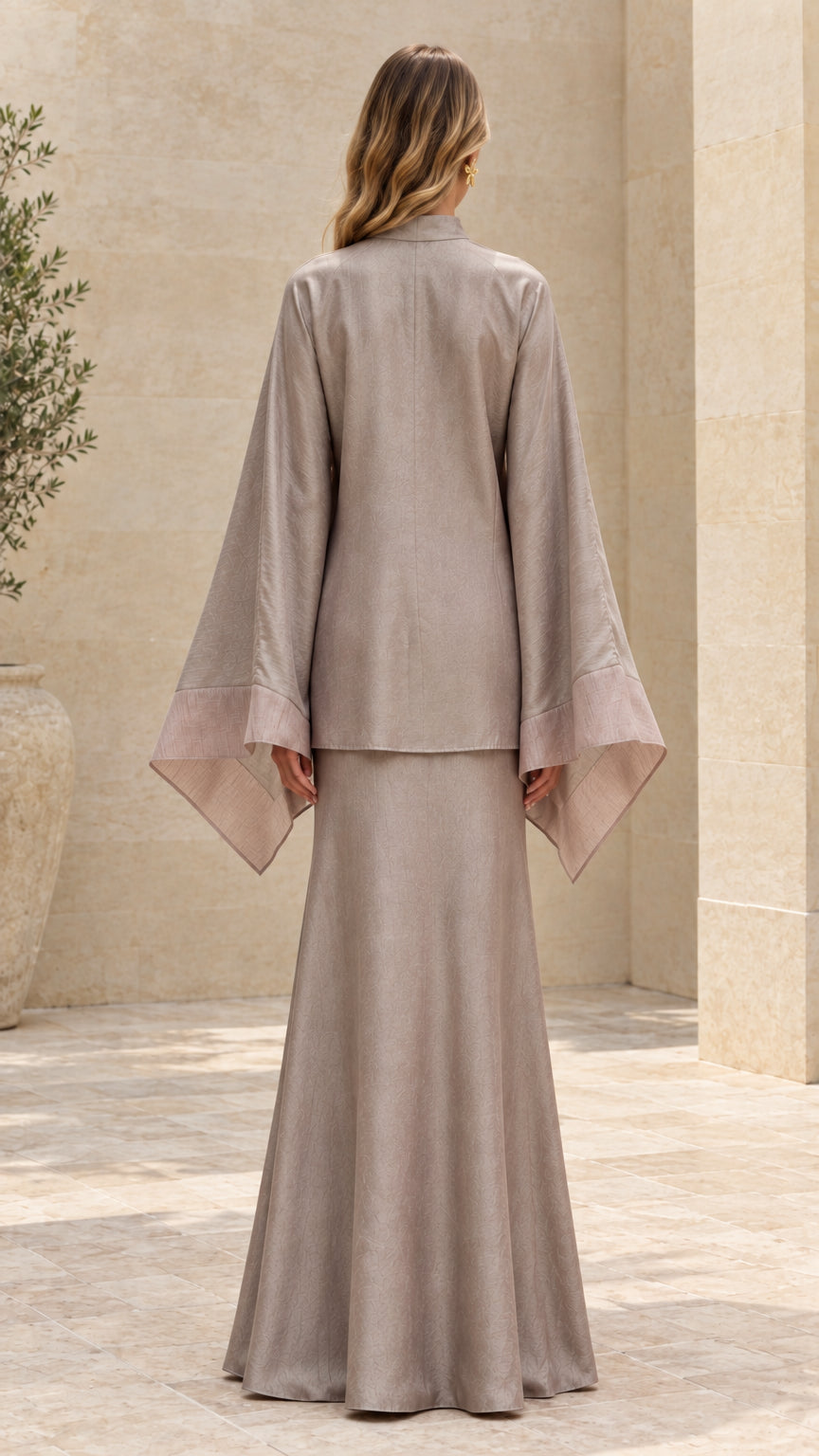 Back view of model in taupe long sleeve tunic and flowing maxi skirt set