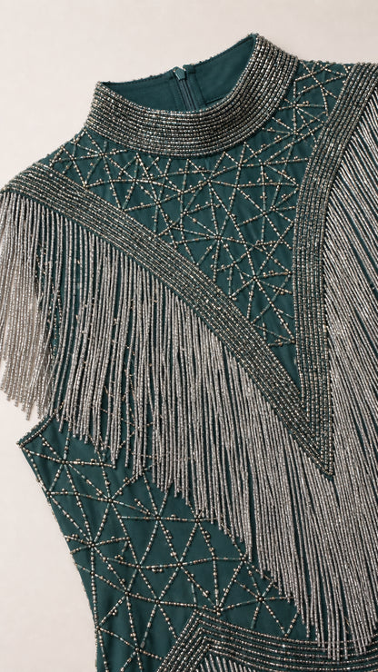 Close-up detail of high neckline and intricate geometric beadwork with fringe