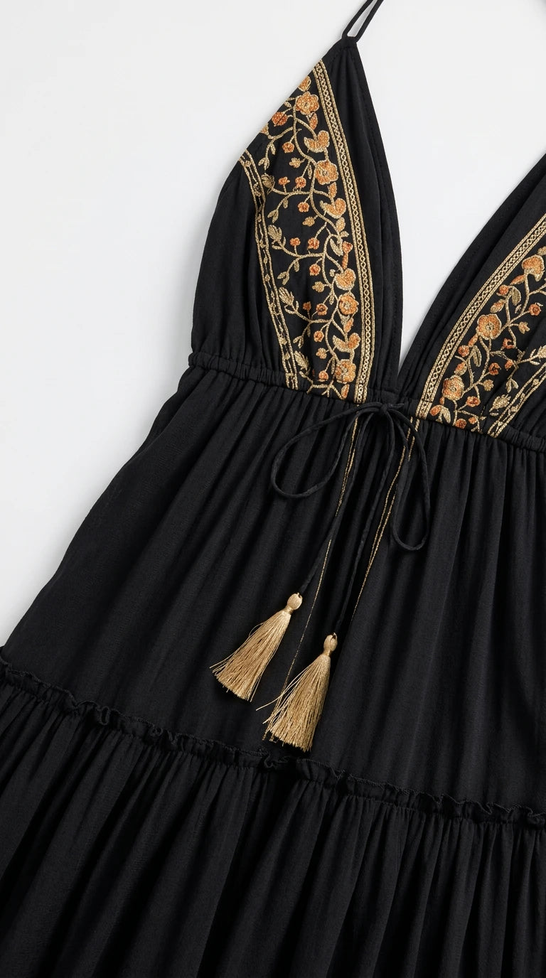 Close-up of contrast floral embroidery and tassel drawstring detail