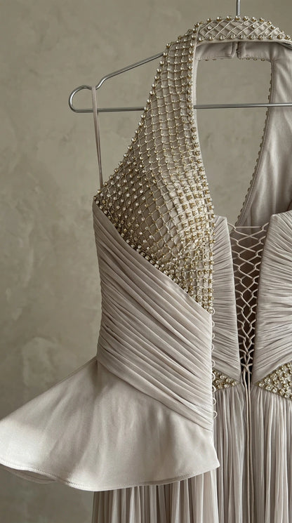 Close-up detail of rhinestone embellishment and ruched pleated bodice