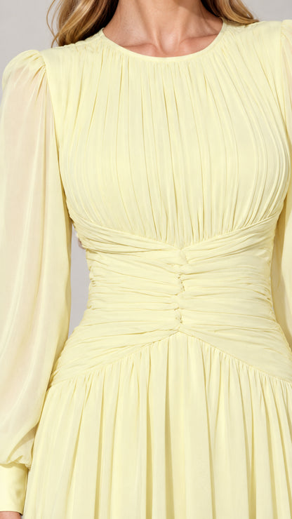 Close-up detail of pleated bodice and ruched waist on pale yellow dress