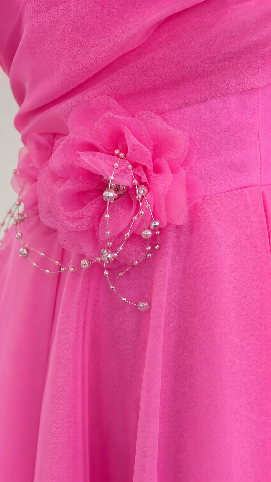 Close-up detail of 3D fabric flower appliqué and delicate beadwork