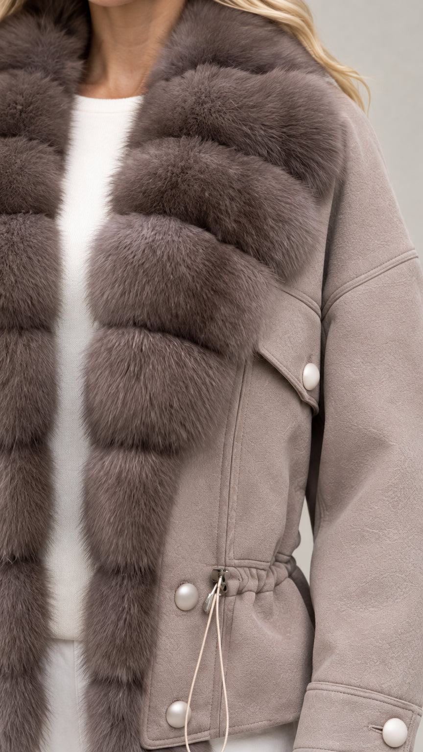 Close-up detail of plush taupe faux fur collar, lapel, and drawstring closure