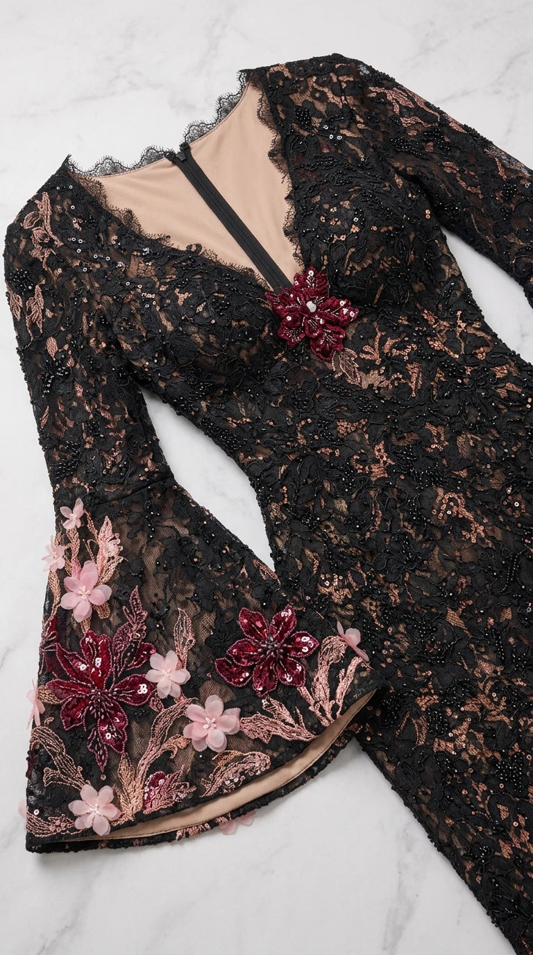 Close-up detail of 3D floral embroidery, beading, and bell sleeve cuff on lace gown