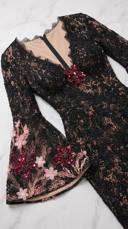 Close-up detail of 3D floral embroidery, beading, and bell sleeve cuff on lace gown