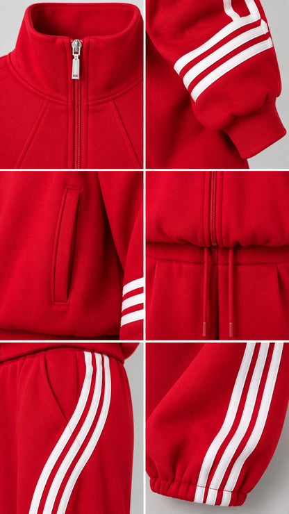 Detailed close-up of zipper, stand collar, ribbed cuffs, and striped pants on red tracksuit