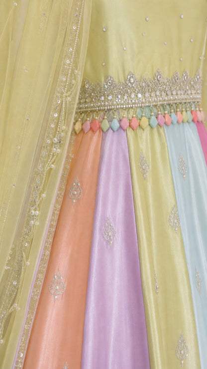 Close-up detail of embroidered waistband with colorful bead fringe and panel fabric