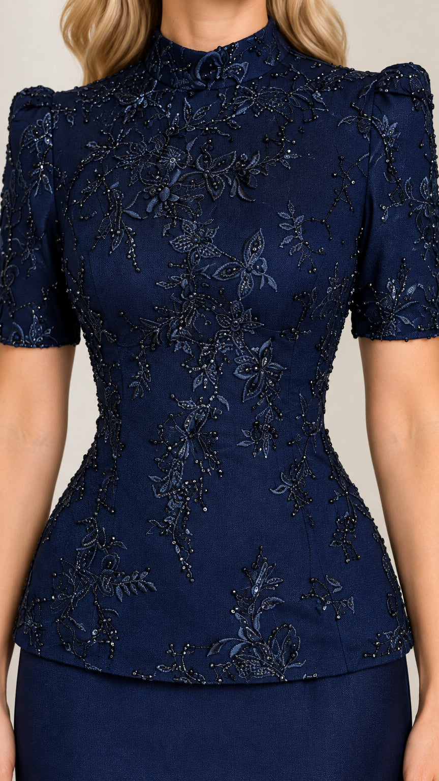Close-up detail of Navy Blue floral beading and high mock neckline