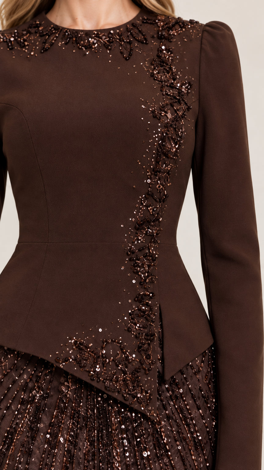 Close-up detail of beaded neckline and asymmetrical peplum bodice embellishment