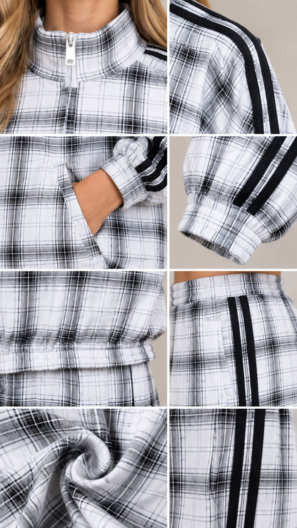 Close-up details of plaid tracksuit zipper collar, cuffs, and pocket stitching