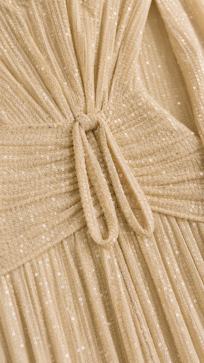 Close-up detail of champagne pleated shimmer fabric and knotted front tie