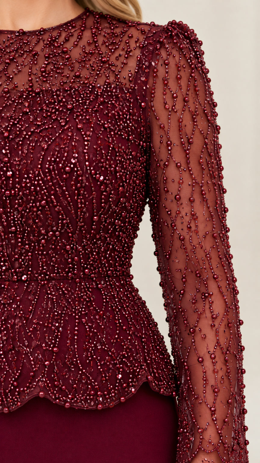 Close up detail of intricate beaded mesh bodice and scalloped peplum