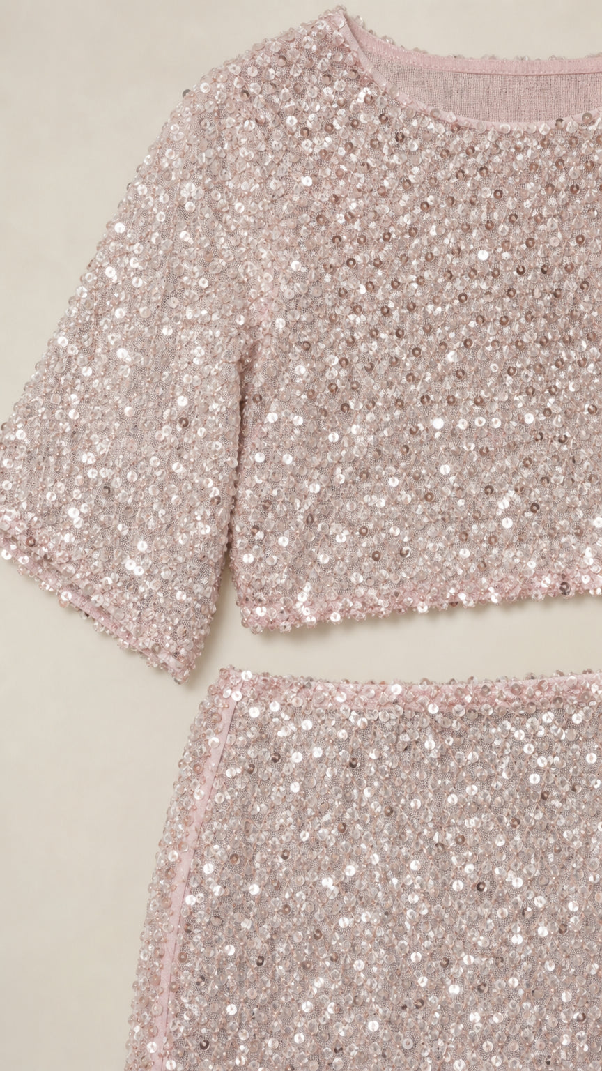 Close-up detail of blush pink sequin mesh fabric and neckline