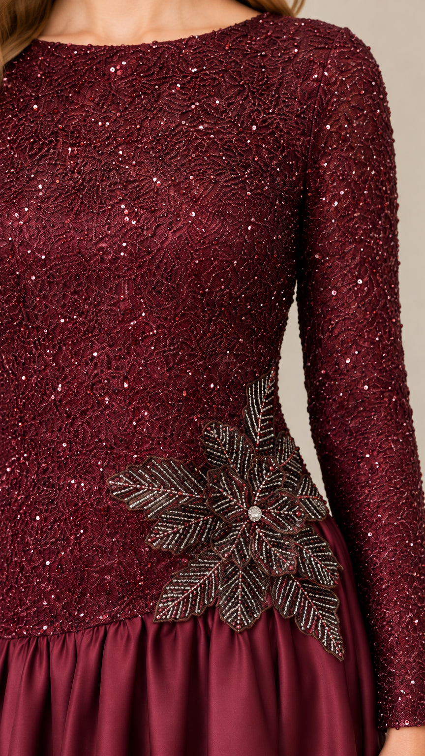 Close-up of burgundy sequin bodice with leaf embroidery applique detail