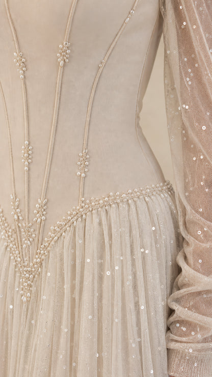 Close-up of structured corset bodice with boning lines and pearl beaded basque waist trim