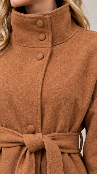 Close up of high stand collar and covered button details on camel coat