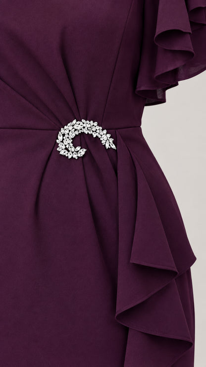 Close-up detail of waist gathering with sparkling crystal brooch accent on Plum dress