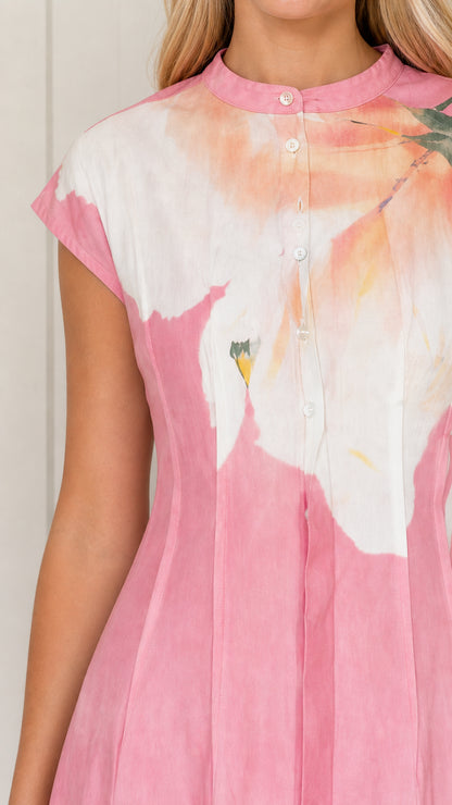 Close-up detail of mandarin collar, button placket, and cap sleeves on pink floral dress