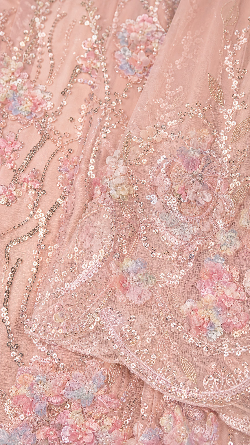 Close-up detail of delicate floral sequin and bead embroidery on mesh fabric