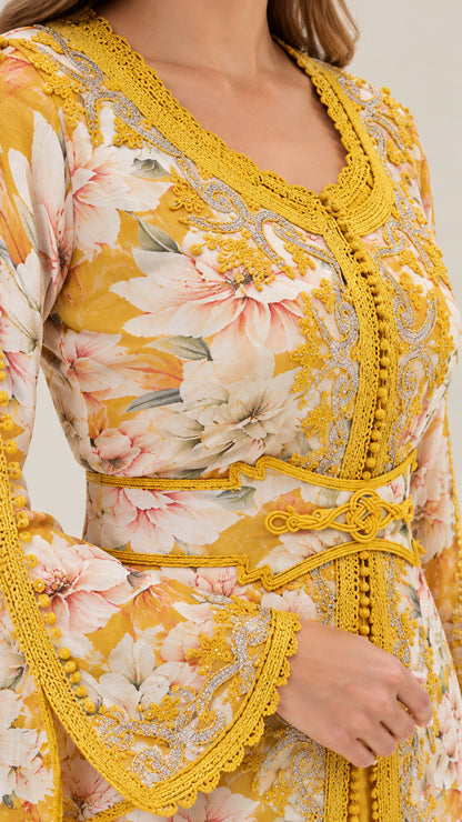 Close-up of intricate braided embroidery and tie belt on floral kaftan dress