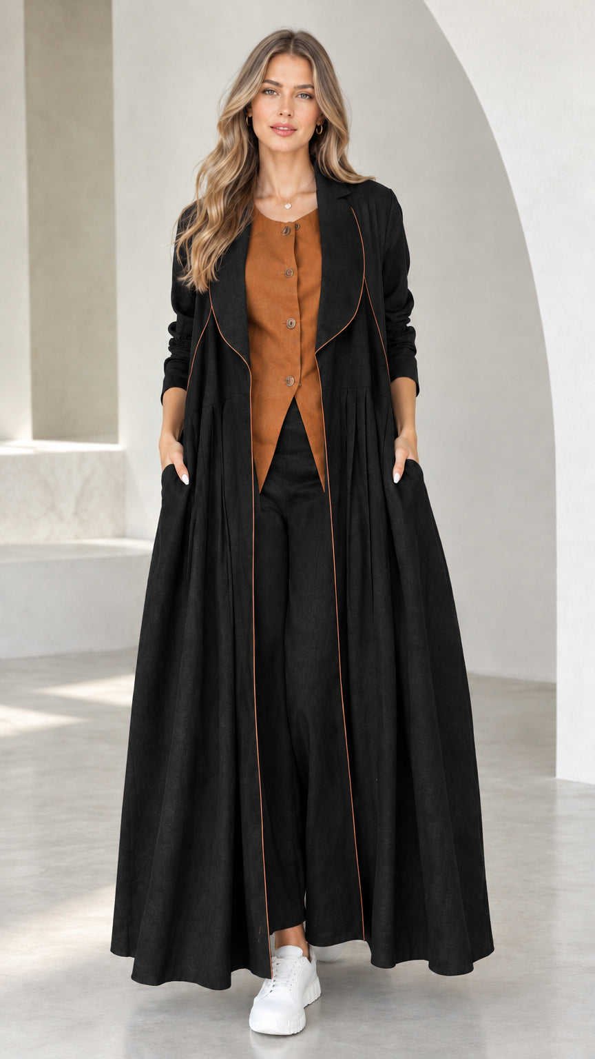 Front view of model wearing Black pleated maxi duster coat