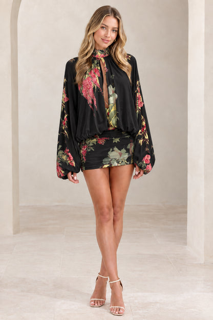 Woman wearing black floral long lantern sleeve ruched mini dress