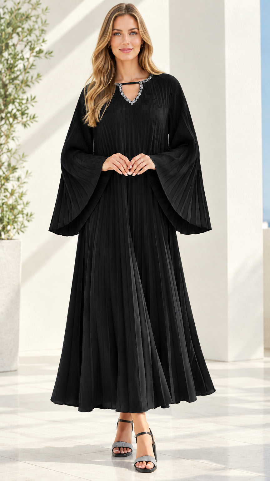 Front view of black pleated maxi dress with crystal-accented neckline