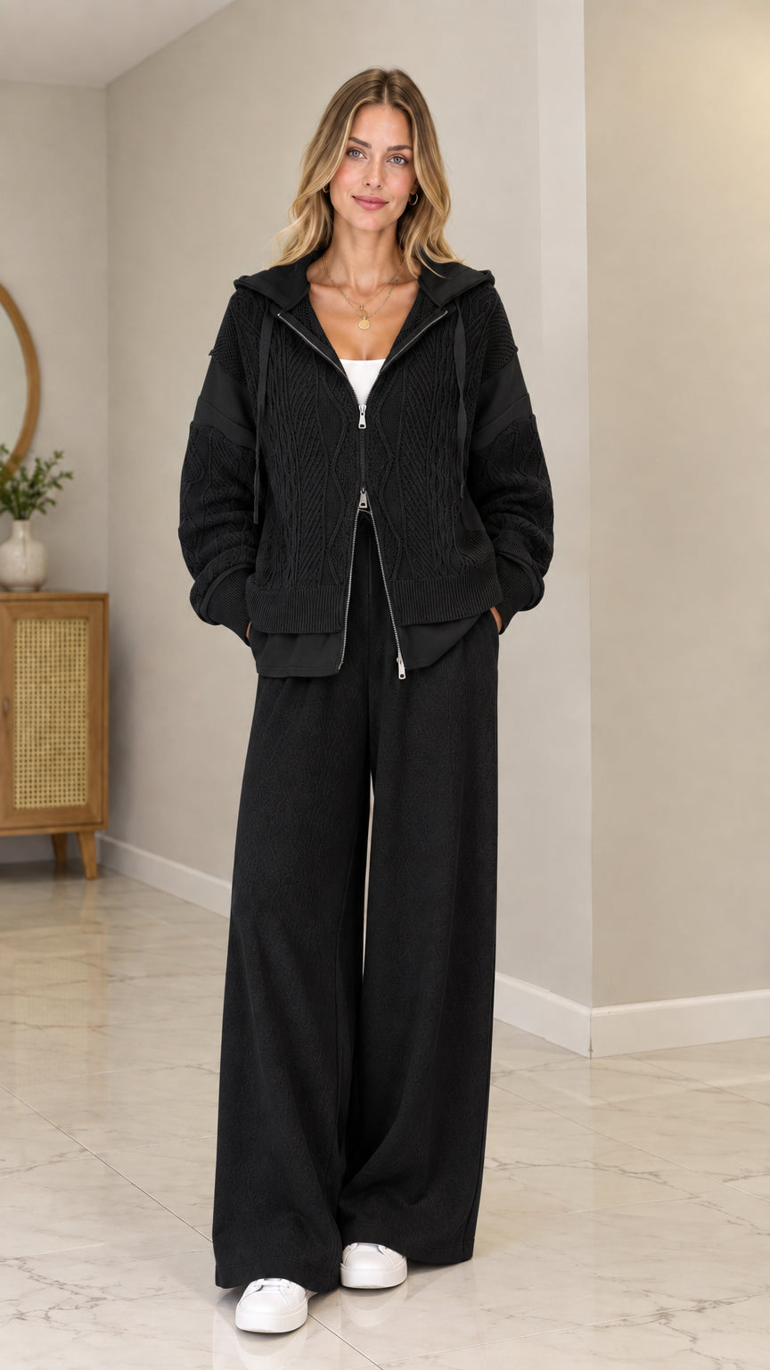 Front view of model wearing Black cable-knit zip-up hooded cardigan set