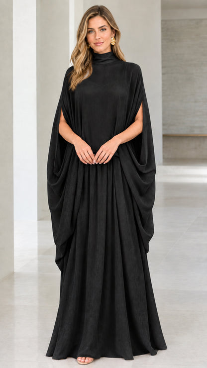 Front view of model wearing black high neck cape sleeve maxi dress