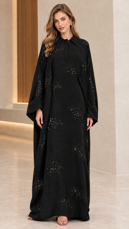Front full-length view of woman wearing black collared sequin embellished abaya maxi dress