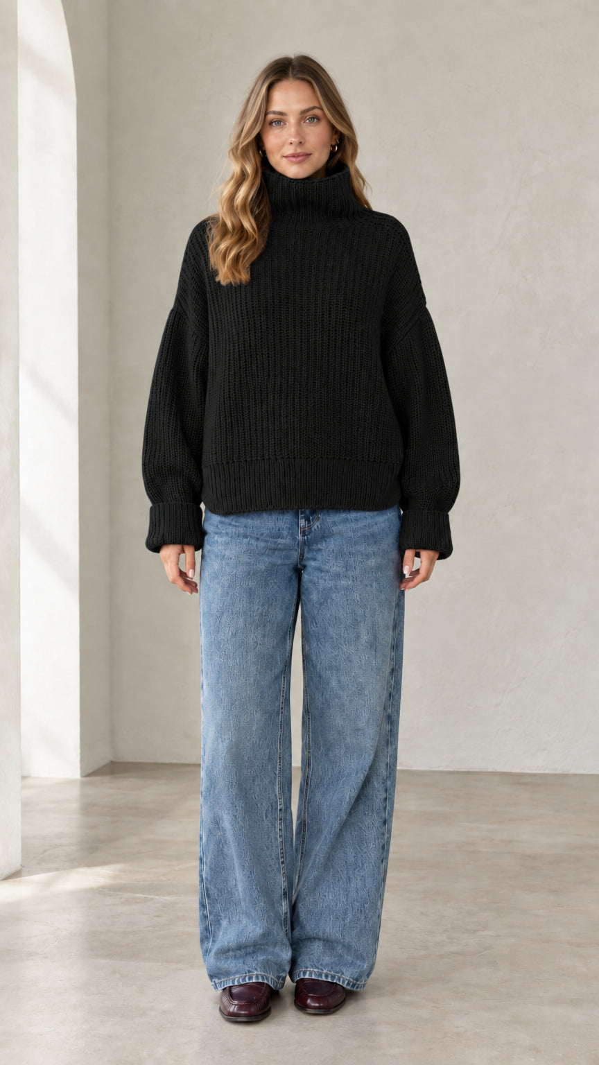 Model wearing black chunky ribbed turtleneck knit pullover sweater